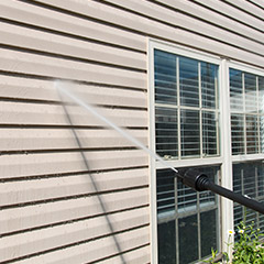 Power washing exterior of home