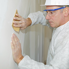 Man removing popcorn paint