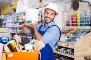 paint maker holding a gallon of paint