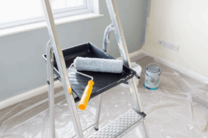 a paint roller and ladder